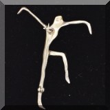 J069. Silver tone dancing figure pin. - $18 